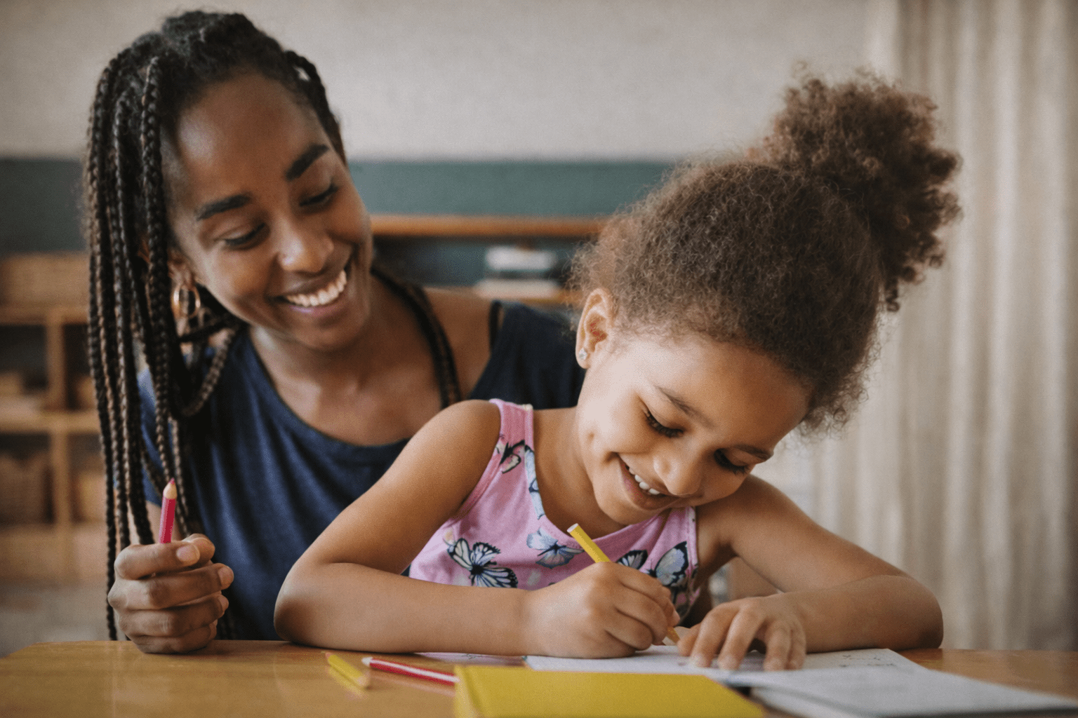 mother observing daughter writing
