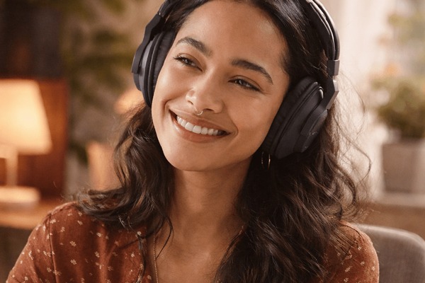 Montessori mentor listening with headphones in home office